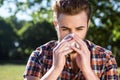 Handsome hipster blowing his nose Royalty Free Stock Photo