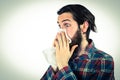 Handsome hipster blowing his nose Royalty Free Stock Photo