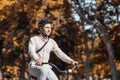 Handsome hipster cycling through city. Guy on bike in helmet ride to work