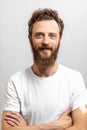 Handsome hipster man with beard smiling at camera over white background. Royalty Free Stock Photo