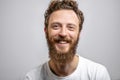 Handsome hipster man with beard smiling at camera over white background. Royalty Free Stock Photo