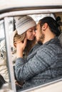 Handsome hipster Man and beauty woman kiss each other sitting in the retro car . Valintine`s Day concept. Vertical Royalty Free Stock Photo