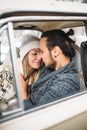 Handsome hipster Man and beauty woman kiss each other sitting in the retro car . Valintine`s Day concept. Vertical Royalty Free Stock Photo