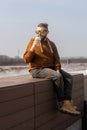 Stylish handsome hipster man holding drinks cocktail, spring time Royalty Free Stock Photo