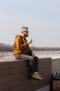 Stylish handsome hipster man holding drinks cocktail, spring time. Copy space Royalty Free Stock Photo