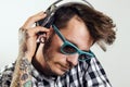 Handsome hipster man with sunglasses listening to music Royalty Free Stock Photo