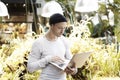 Handsome hipster man working on laptop computer outdoor in park. Male portrait sunny day, business concept.