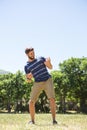 Handsome hipster playing air guitar