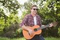 Handsome hipster playing the guitar Royalty Free Stock Photo