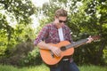 Handsome hipster playing the guitar Royalty Free Stock Photo