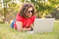 Handsome hipster using laptop in the park