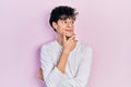 Handsome hipster young man wearing casual white shirt with hand on chin thinking about question, pensive expression Royalty Free Stock Photo