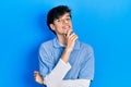 Handsome hipster young man wearing vintage look smiling looking confident at the camera with crossed arms and hand on chin Royalty Free Stock Photo