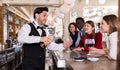 Barman serving drinks on bar