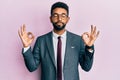 Handsome hispanic business man with beard wearing business suit and tie relax and smiling with eyes closed doing meditation Royalty Free Stock Photo