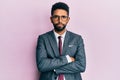 Handsome hispanic business man with beard wearing business suit and tie skeptic and nervous, disapproving expression on face with Royalty Free Stock Photo