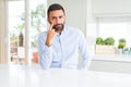 Handsome hispanic business man Pointing to the eye watching you gesture, suspicious expression Royalty Free Stock Photo