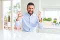 Handsome hispanic business man Shouting frustrated with rage, hands trying to strangle, yelling mad Royalty Free Stock Photo