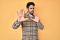 Handsome hispanic man with beard wearing casual clothes afraid and terrified with fear expression stop gesture with hands, Royalty Free Stock Photo
