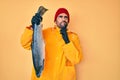 Handsome hispanic man with beard wearing fisherman equipment serious face thinking about question with hand on chin, thoughtful