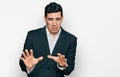 Handsome hispanic man wearing business clothes disgusted expression, displeased and fearful doing disgust face because aversion Royalty Free Stock Photo