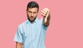 Handsome hispanic man wearing casual clothes looking unhappy and angry showing rejection and negative with thumbs down gesture Royalty Free Stock Photo