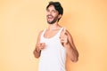 Handsome hispanic man wearing summer look and sunglasses pointing fingers to camera with happy and funny face Royalty Free Stock Photo