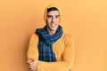 Handsome hispanic man wearing wool hat and winter scarf happy face smiling with crossed arms looking at the camera Royalty Free Stock Photo