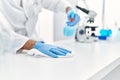 Handsome hispanic man working as scientific cleaning the table at laboratory Royalty Free Stock Photo