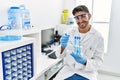 Handsome hispanic man working as scientific holding test tubes at laboratory Royalty Free Stock Photo