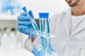 Handsome hispanic man working as scientific holding test tubes at laboratory Royalty Free Stock Photo