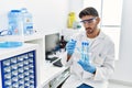 Handsome hispanic man working as scientific holding test tubes at laboratory Royalty Free Stock Photo