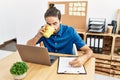 Handsome hispanic man working and drinking a coffee at the office Royalty Free Stock Photo