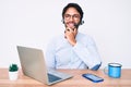 Handsome hispanic man working at the office wearing operator headset smiling looking confident at the camera with crossed arms and Royalty Free Stock Photo