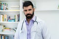 Handsome hispanic mature doctor with beard Royalty Free Stock Photo