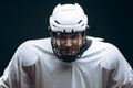 Handsome hockey player. Smiling at camera isolated on black background.
