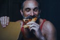 Handsome hungry man is eating pizza. Royalty Free Stock Photo