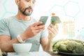 Handsome interested man holding and examining a broccoli.