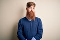 Handsome Irish redhead business man with beard standing over isolated background Relaxed with serious expression on face Royalty Free Stock Photo