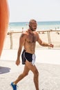 Handsome Israeli man walking along the beach promanade of Tel Av Royalty Free Stock Photo