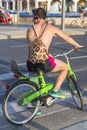 Handsome Israeli men riding a bike along the beach of Tel Aviv