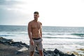 Handsome italian man posing shirtless on the beach. Muscular man outdoor Royalty Free Stock Photo