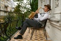 Handsome jazzman enjoys playing saxophone relaxing on terrace