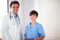 Handsome latin doctor and beautiful nurse standing Royalty Free Stock Photo