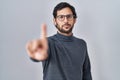 Handsome latin man standing over isolated background pointing with finger up and angry expression, showing no gesture Royalty Free Stock Photo