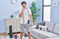 Handsome latin man wearing sportswear at home with hand on chin thinking about question, pensive expression Royalty Free Stock Photo