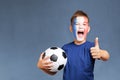 Handsome screaming french fanboy holds soccer ball and gesturing thumbs up Royalty Free Stock Photo