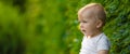 Handsome little boy, cheerful sitting on the lawn