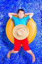 Handsome little boy dozing off in the pool Royalty Free Stock Photo