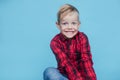 Handsome little boy with red shirt. Fashion. Studio portrait over blue background Royalty Free Stock Photo